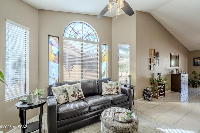 living room featuring light tile patterned floors, plenty of natural light, lofted ceiling, and ceiling fan