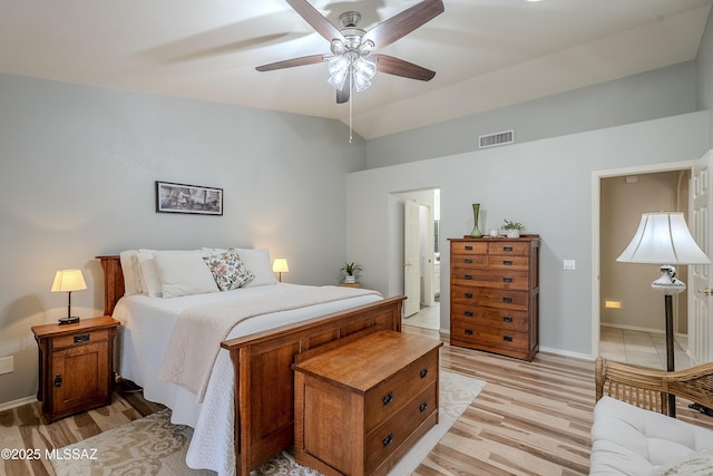 bedroom with ceiling fan, lofted ceiling, and light wood-type flooring