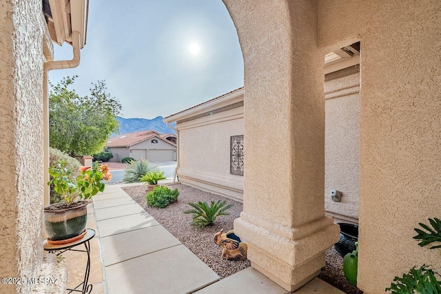 view of patio / terrace with a mountain view and a garage