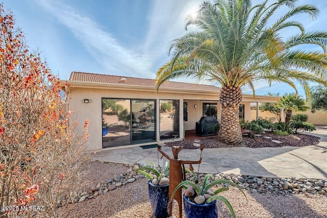 back of house with a patio area