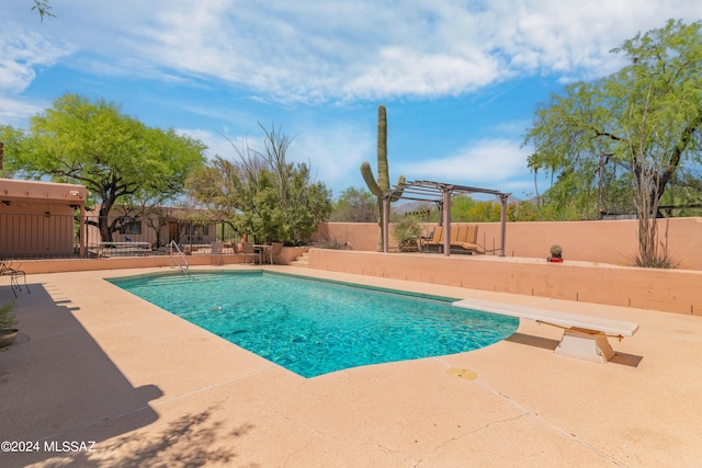 view of swimming pool featuring a diving board, a pergola, and a patio