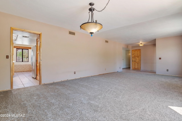 unfurnished room with light carpet