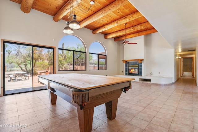 rec room with wood ceiling, ceiling fan, beam ceiling, light tile patterned floors, and a fireplace