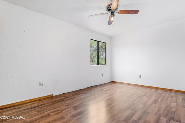 unfurnished room with ceiling fan and hardwood / wood-style floors