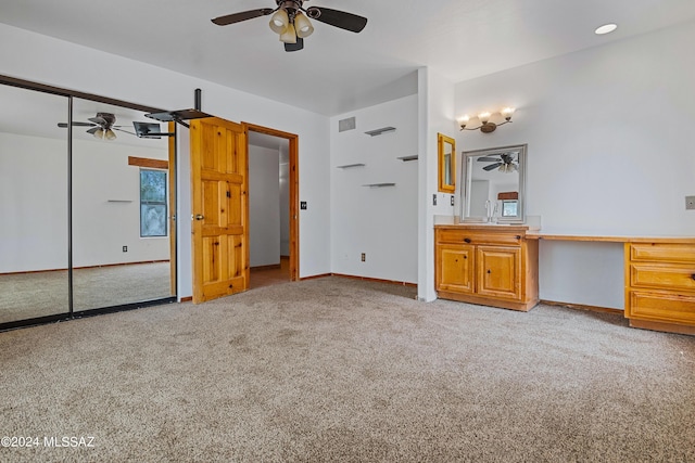 unfurnished bedroom featuring light carpet, ceiling fan, a closet, and sink