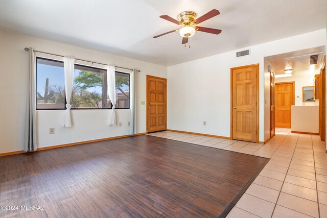 spare room featuring ceiling fan and light wood-type flooring