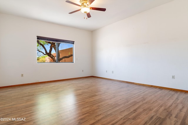 empty room featuring hardwood / wood-style floors and ceiling fan