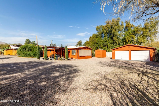 view of front of property featuring a garage and an outbuilding