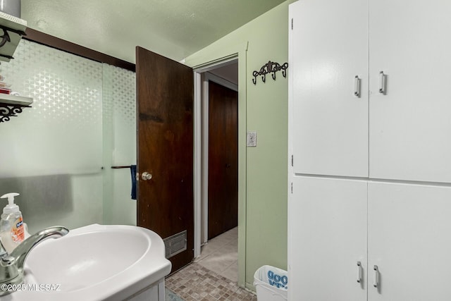 bathroom with sink and tile patterned floors