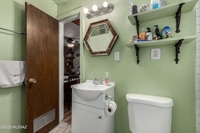 bathroom featuring ceiling fan, vanity, and toilet