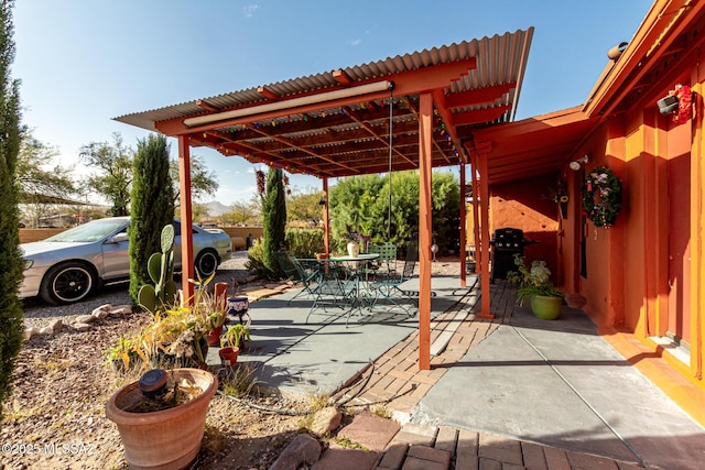 view of patio with grilling area and a pergola