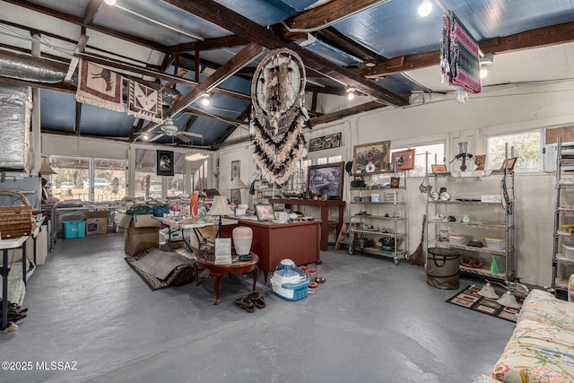 misc room with concrete floors and high vaulted ceiling