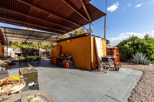 view of patio featuring a storage shed