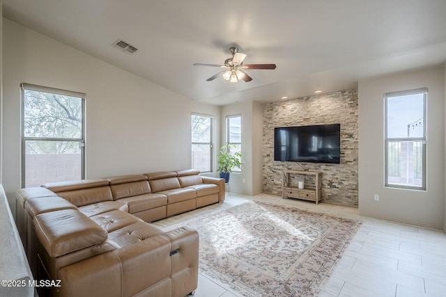 living room with ceiling fan and vaulted ceiling