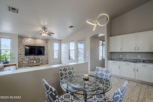 dining area featuring ceiling fan, lofted ceiling, and a wealth of natural light