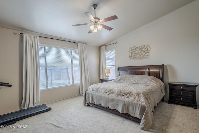 bedroom featuring multiple windows, light carpet, ceiling fan, and lofted ceiling