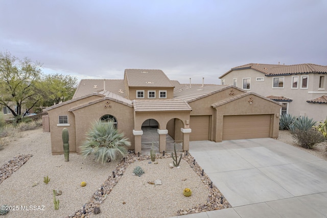 mediterranean / spanish-style home with a garage