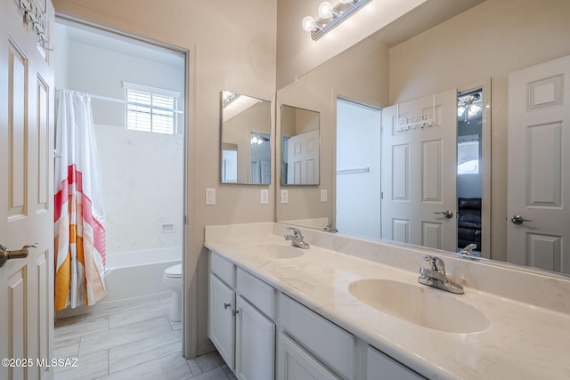 full bathroom with ceiling fan, shower / bath combo with shower curtain, vanity, and toilet