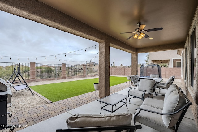 view of patio / terrace with a trampoline and ceiling fan