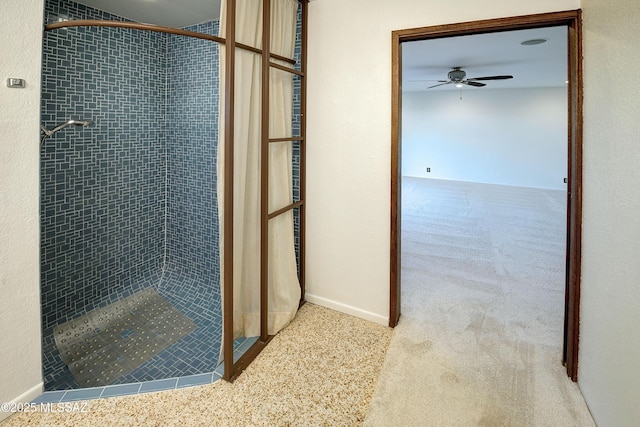 bathroom with ceiling fan and a tile shower