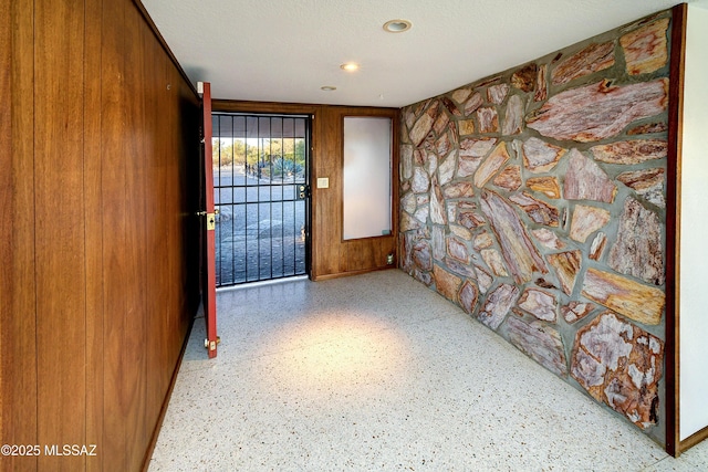 foyer featuring wood walls