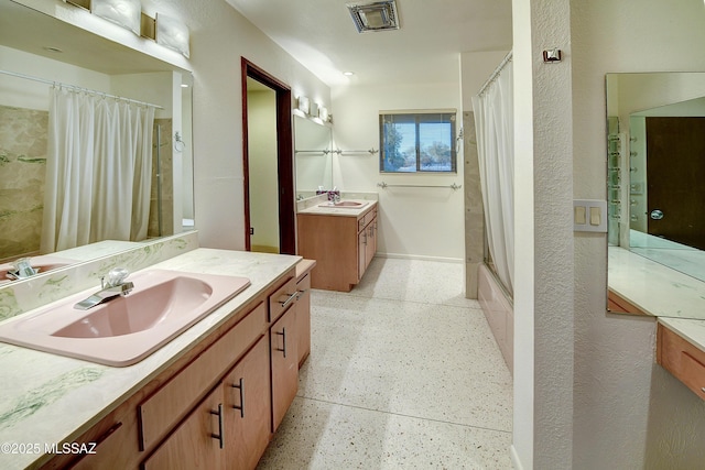 bathroom with shower / tub combo and vanity