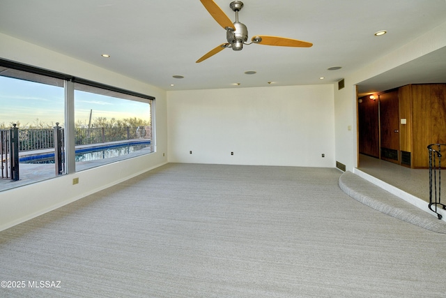 carpeted empty room with ceiling fan