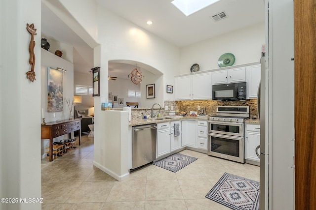 kitchen featuring sink, ceiling fan, decorative backsplash, white cabinetry, and stainless steel appliances