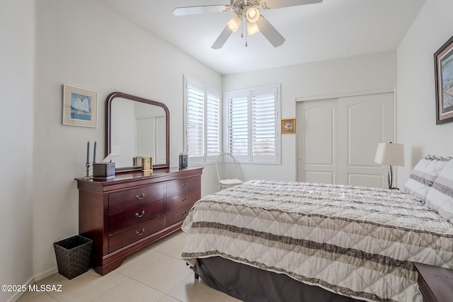 bedroom with ceiling fan, a closet, and light tile patterned flooring