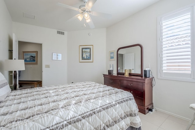 tiled bedroom with ceiling fan