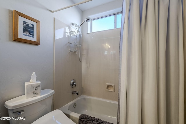 bathroom with shower / bath combination with curtain and toilet