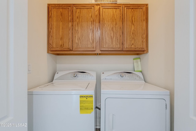 laundry room featuring cabinets and washing machine and dryer