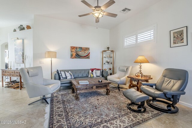 tiled living room with ceiling fan