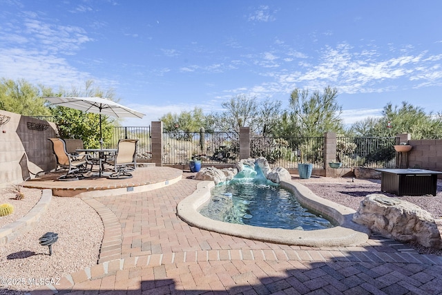 view of swimming pool with pool water feature and a patio area