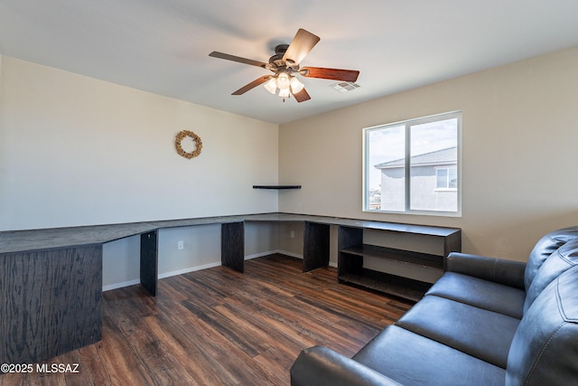 office featuring visible vents, built in study area, ceiling fan, wood finished floors, and baseboards