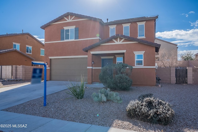 view of front of house with driveway, a garage, fence, and stucco siding