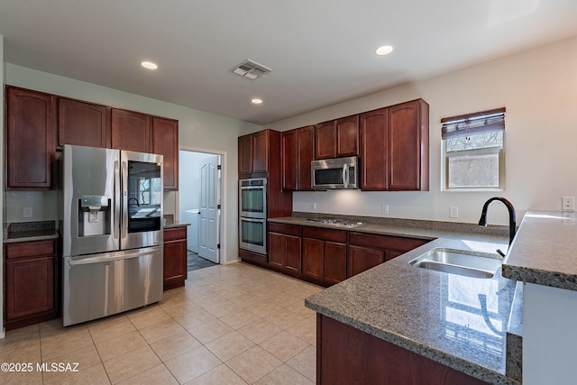 kitchen with stainless steel appliances, recessed lighting, visible vents, light tile patterned flooring, and a sink