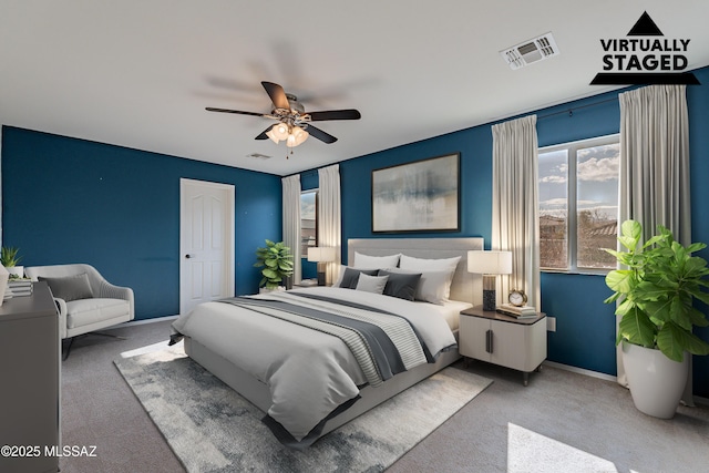 bedroom featuring carpet floors, visible vents, baseboards, and a ceiling fan