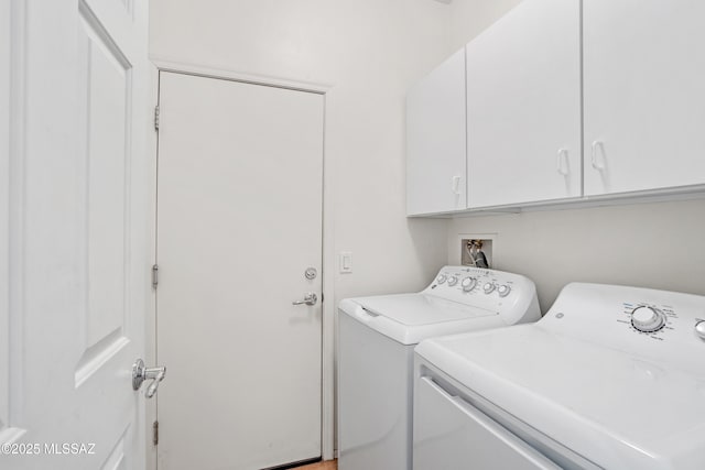 laundry area with cabinets and washing machine and dryer