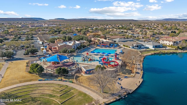 birds eye view of property with a water and mountain view