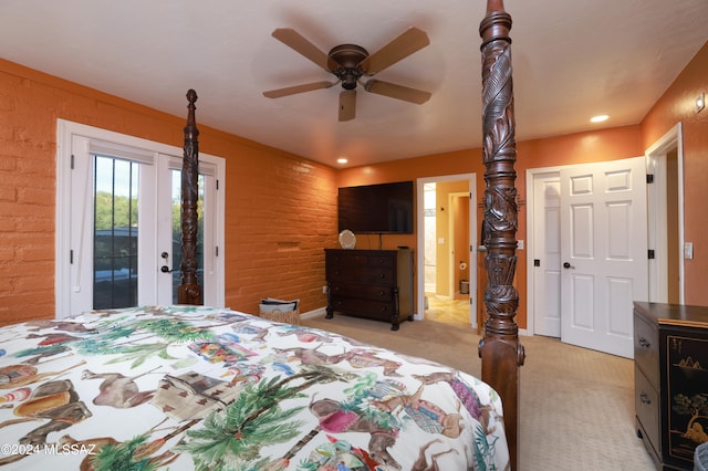 bedroom featuring access to exterior, ceiling fan, brick wall, and light carpet