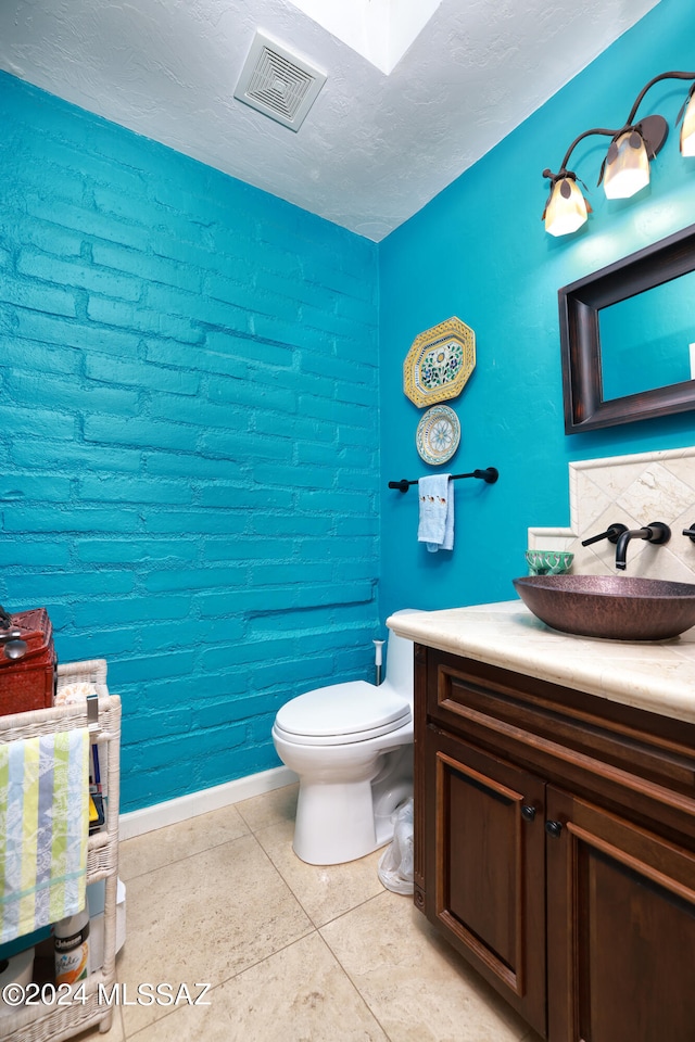 bathroom featuring tile patterned floors, vanity, and toilet