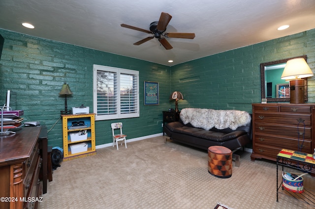 bedroom featuring carpet flooring, ceiling fan, and brick wall