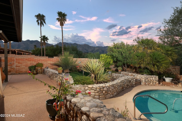 view of pool featuring a mountain view and a patio