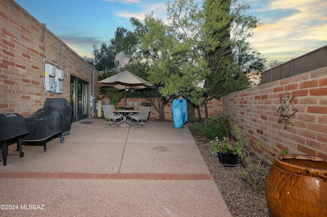 view of patio terrace at dusk