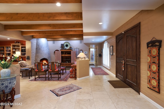 foyer featuring beam ceiling