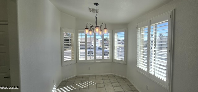 unfurnished dining area with light tile patterned floors and an inviting chandelier