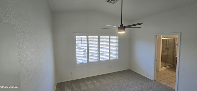 spare room featuring ceiling fan, carpet floors, and lofted ceiling