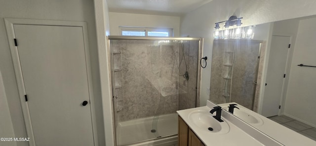 bathroom featuring vanity, an enclosed shower, and tile patterned flooring