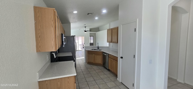 kitchen with appliances with stainless steel finishes, sink, light tile patterned flooring, ceiling fan, and lofted ceiling